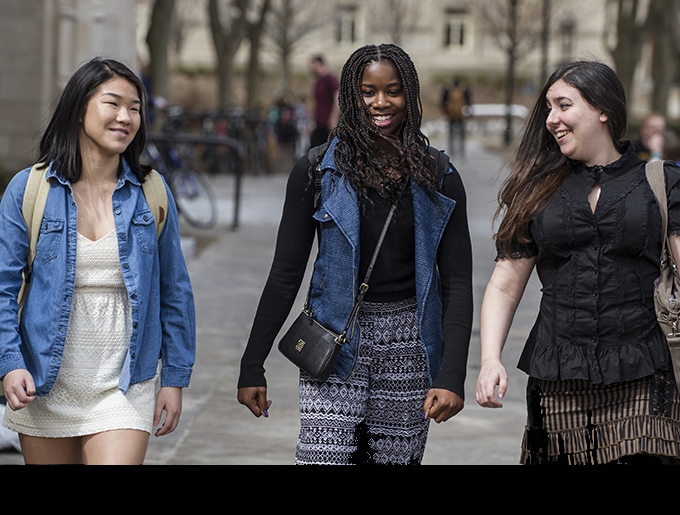 three students walking together on Pitt campus